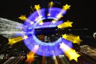The famous euro sign landmark is photographed outside the former head quarters of the European Central Bank (ECB) in Frankfurt, late evening January 20, 2015. REUTERS/Kai Pfaffenbach