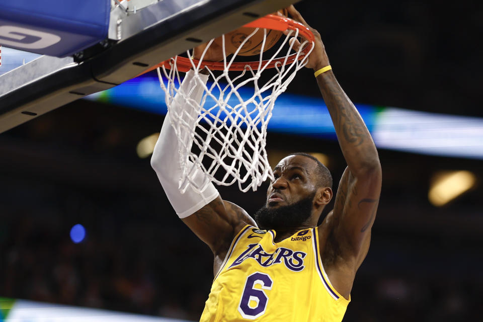 LA Lakers star LeBron James slams the ball against the Orlando Magic. 