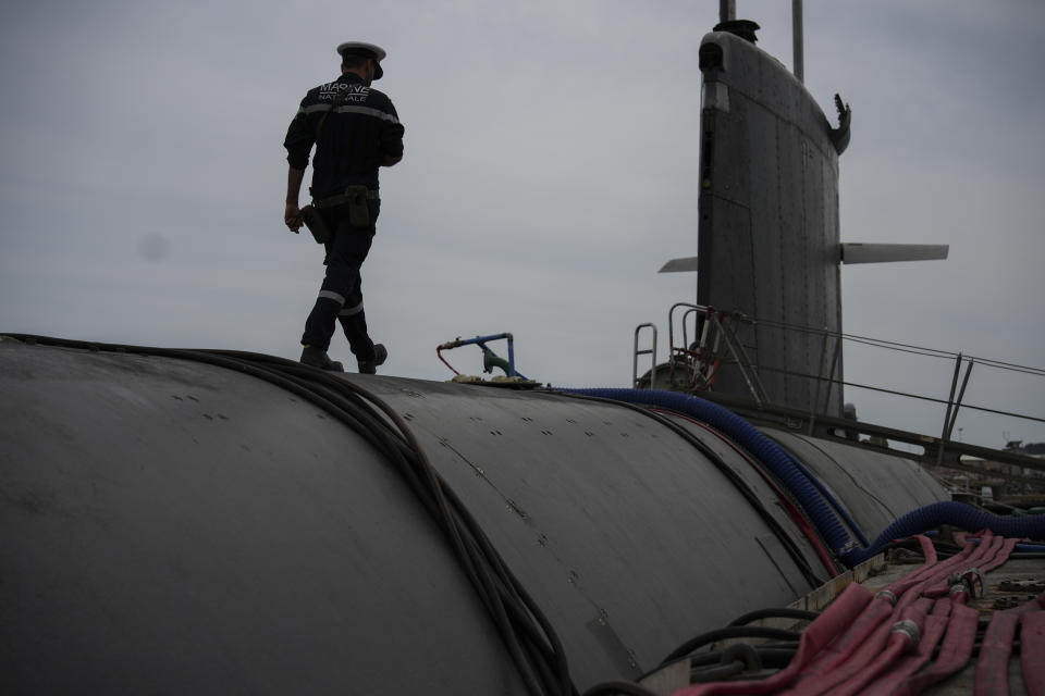 A sailor prepares a French Rubis-class submarine at the Toulon naval base in southern France, Monday, April 15, 2024. The nuclear powered submarine will be guarding France's Charles de Gaulle aircraft carrier during training exercises dubbed Neptune Strike in the Mediterranean with the 32-nation NATO military alliance. (AP Photo/Daniel Cole)