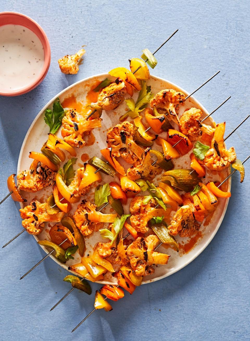 <p>We here at Delish know the value of adding spicy buffalo sauce to cauliflower (see our <a href="https://www.delish.com/cooking/recipe-ideas/recipes/a49855/cauliflower-wings-recipe/" rel="nofollow noopener" target="_blank" data-ylk="slk:buffalo cauliflower wings;elm:context_link;itc:0;sec:content-canvas" class="link ">buffalo cauliflower wings</a>), but we never thought to grill the cauli up… until now. These buffalo cauliflower kebabs put all your favorite flavors from <a href="https://www.delish.com/cooking/recipe-ideas/recipes/a51133/classic-buffalo-wings-recipe/" rel="nofollow noopener" target="_blank" data-ylk="slk:classic buffalo wings;elm:context_link;itc:0;sec:content-canvas" class="link ">classic buffalo wings</a> onto skewers–and they're vegetarian to boot!</p><p>Get the <strong><a href="https://www.delish.com/cooking/recipe-ideas/a39540046/buffalo-cauliflower-kebabs-recipe/" rel="nofollow noopener" target="_blank" data-ylk="slk:Buffalo Cauliflower Kebabs recipe;elm:context_link;itc:0;sec:content-canvas" class="link ">Buffalo Cauliflower Kebabs recipe</a></strong>.</p>