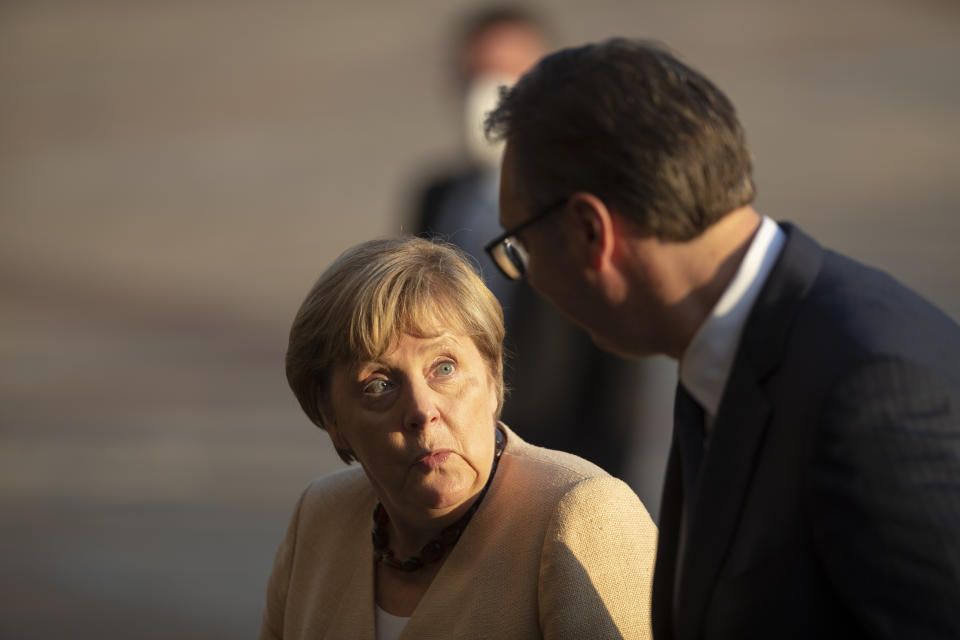 German Chancellor Angela Merkel, left, is accompanied by Serbia's president Aleksandar Vucic in Belgrade, Serbia, Monday, Sept. 13, 2021. Merkel is on a farewell tour of the Western Balkans, as she announced in 2018 that she wouldn't seek a fifth term as Germany's Chancellor. (AP Photo/Marko Drobnjakovic)