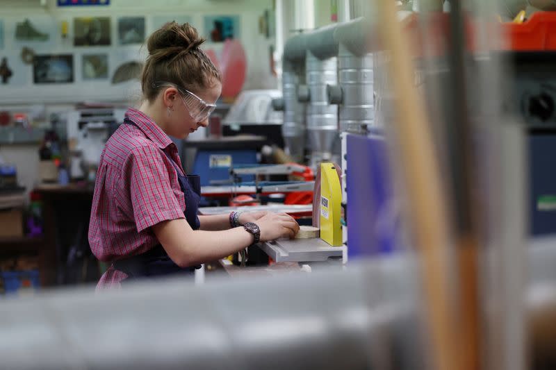 A student uses a disc sander at Malvern St James Girls' School in Britain