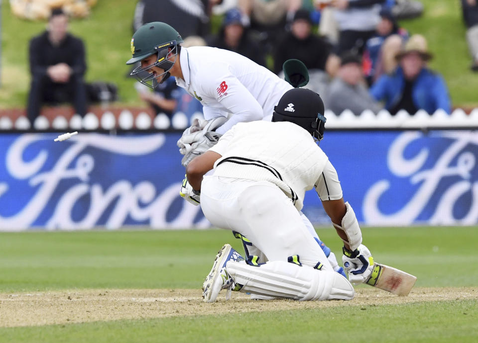 South Africa's Quentin de Kock, left, stumps New Zealand's Jeet Raval for 80 off the bowling of Keshav Maharaj during the second cricket test at the Basin Reserve in Wellington, New Zealand, Saturday, March 18, 2017. (Ross Setford/SNPA via AP)