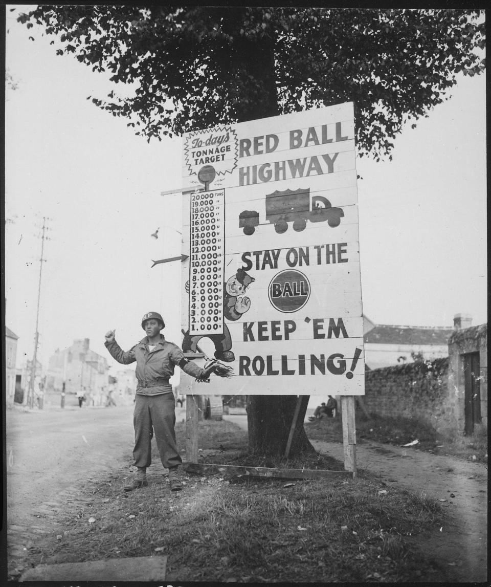 In this Sept. 5, 1944, photograph, Cpl. Charles H. Johnson of the 783rd Military Police Battalion waves on a Red Ball Express convoy near Alenon, France. <a href="https://catalog.archives.gov/id/531220" rel="nofollow noopener" target="_blank" data-ylk="slk:National Archives;elm:context_link;itc:0;sec:content-canvas" class="link ">National Archives</a>