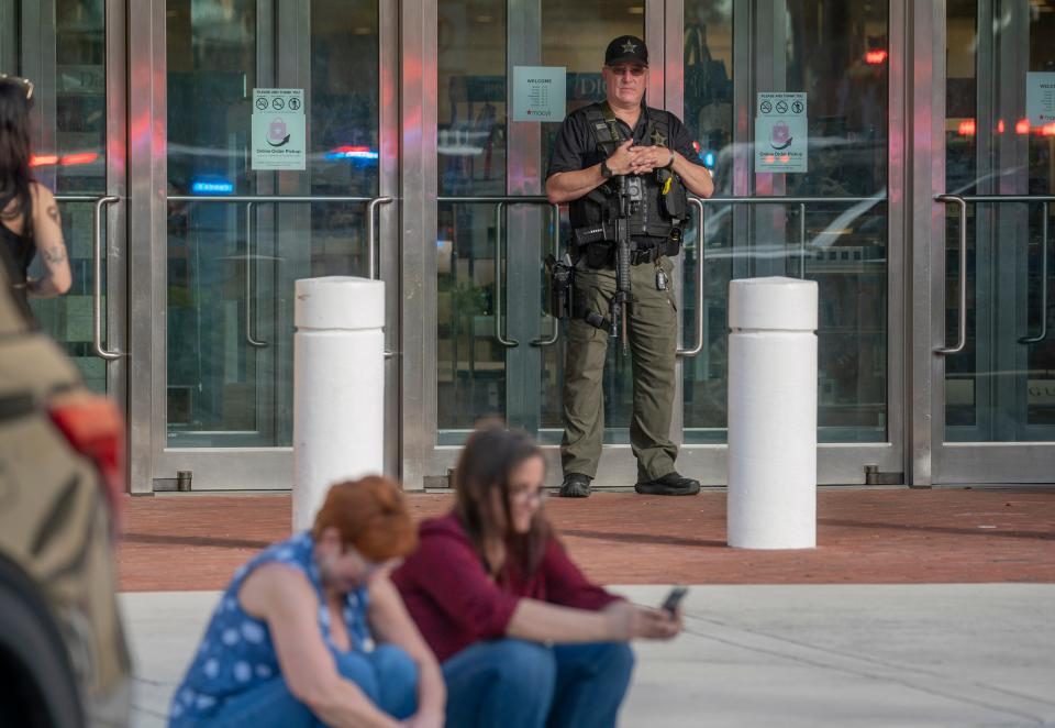 A police officer stands guard outside Macy's at the Gardens Mall after a shooting in the mall on February 14, 2024, in Palm Beach Gardens, Florida.