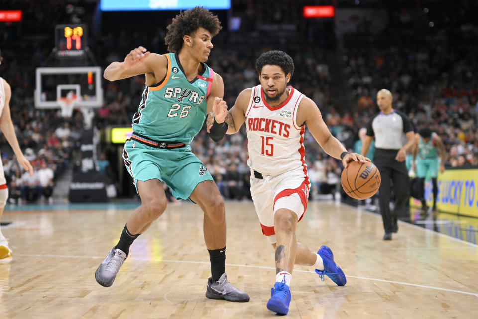 Houston Rockets' Daishen Nix (15) drives against San Antonio Spurs' Dominick Barlow during the first half of an NBA basketball game, Saturday, March 4, 2023, in San Antonio. (AP Photo/Darren Abate)