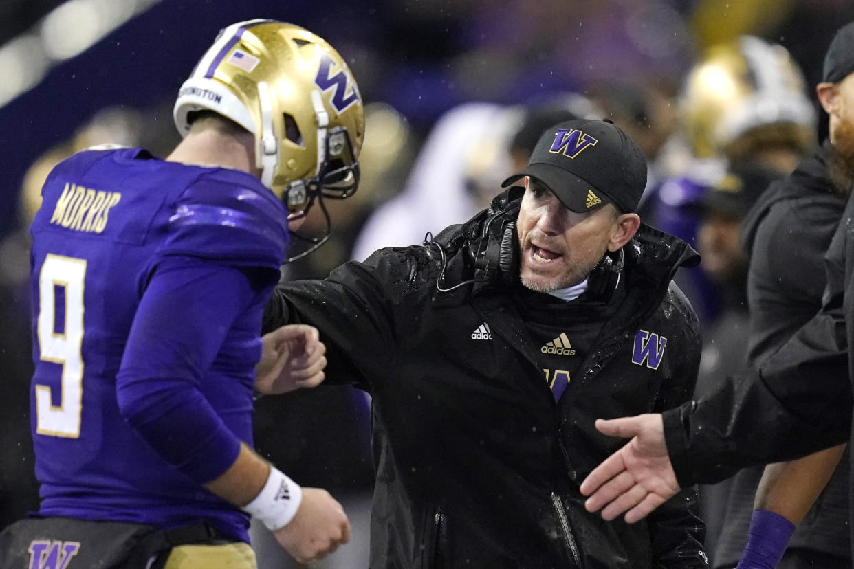 Washington acting coach Bob Gregory, right, talks with quarterback Dylan Morris during the first half of the team's NCAA college football game against Arizona State on Saturday, Nov. 13, 2021, in Seattle. (AP Photo/Elaine Thompson)