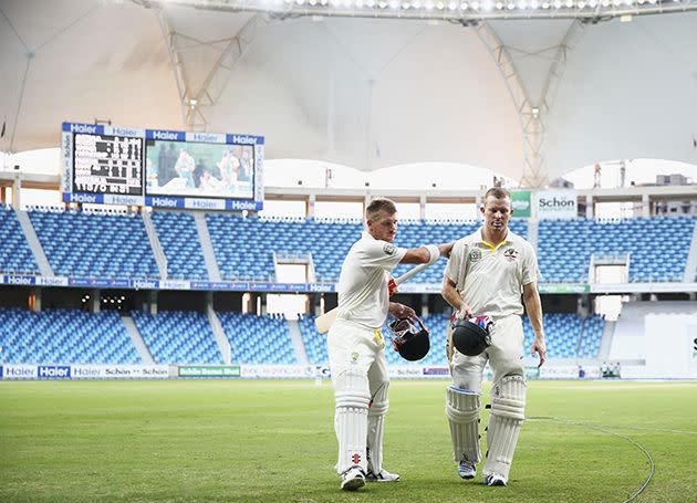 David Warner and Chris Rogers leave the field at stumps at Dubai International Stadium in October last year. Photo: Getty