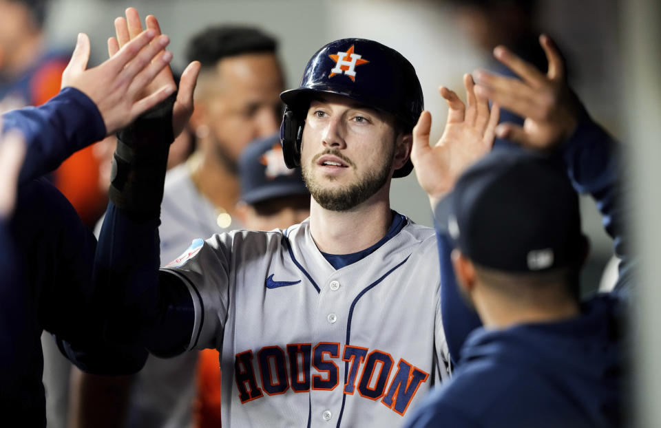 Houston Astros' Kyle Tucker is greeted in the dugout after scoring against the Seattle Mariners during the fourth inning of a baseball game Friday, May 5, 2023, in Seattle. (AP Photo/Lindsey Wasson)