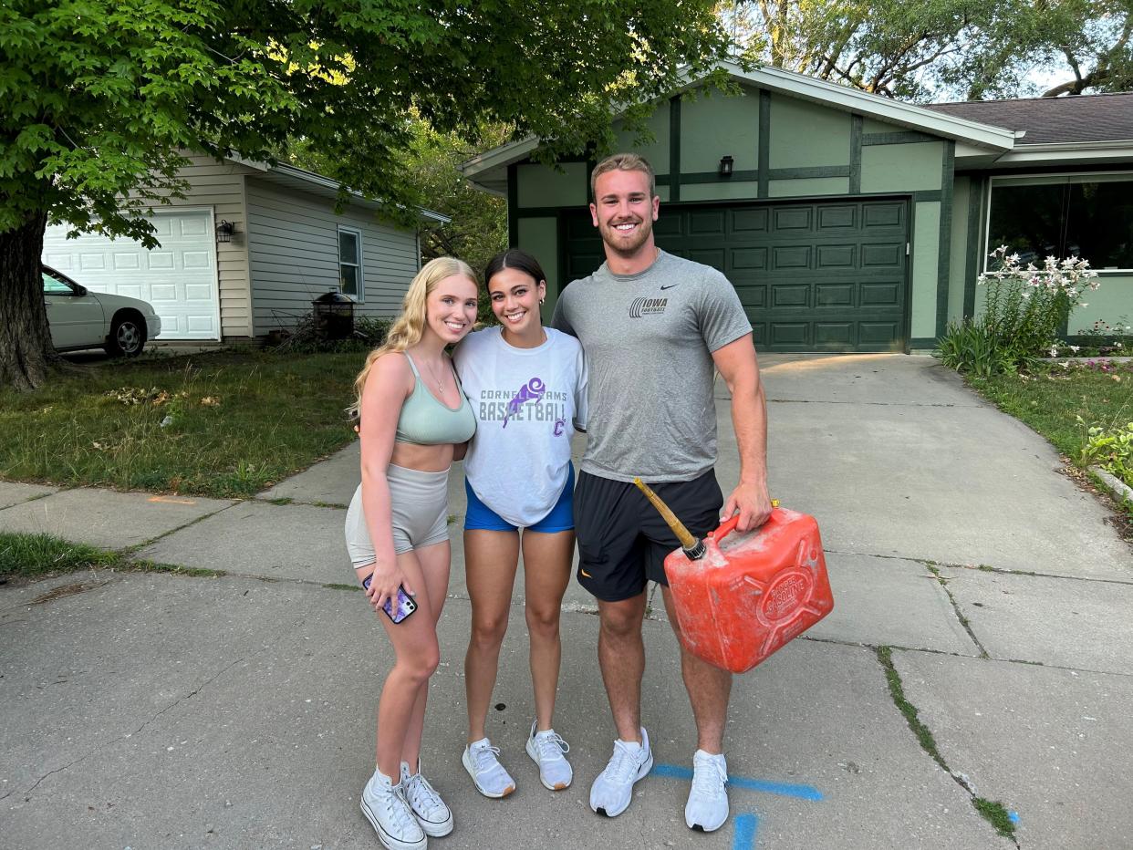 From right: Emma Kuepker, Riley Uthe, and Hawkeyes linebacker Zach Twedt.