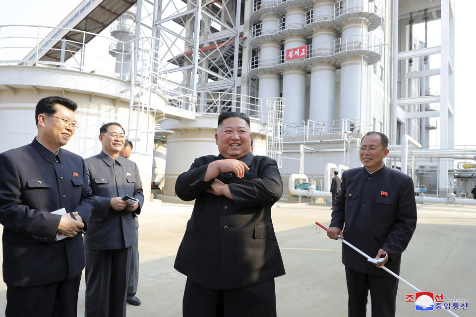 In this Friday, May 1, 2020, photo provided by the North Korean government, North Korean leader Kim Jong Un, center, visits a fertiliser factory in South Pyongan, near Pyongyang, North Korea.