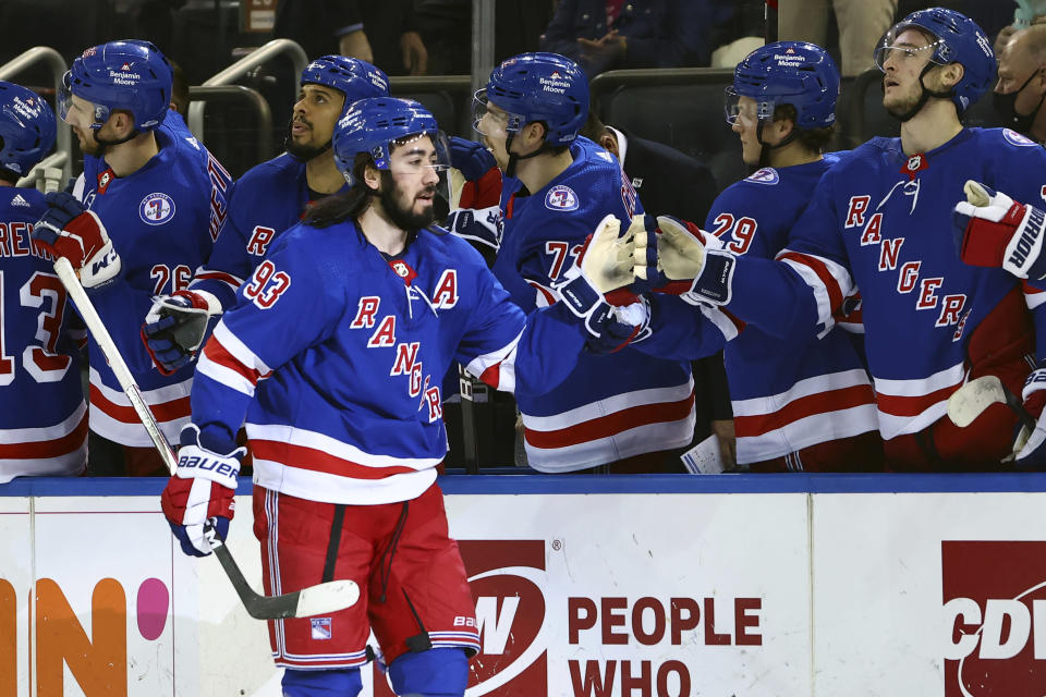 New York Rangers center Mika Zibanejad (93) is congratulated by teammates after scoring a goal against the Tampa Bay Lightning during the first period of an NHL hockey game, Sunday, Jan 2, 2022, at Madison Square Garden in New York. (AP Photo/Rich Schultz)