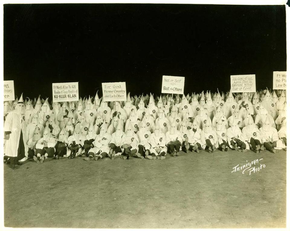 A 1920s Ku Klux Klan gathering of the Fort Worth Klan No. 101, with Klan members in robes and hoods holding signs.