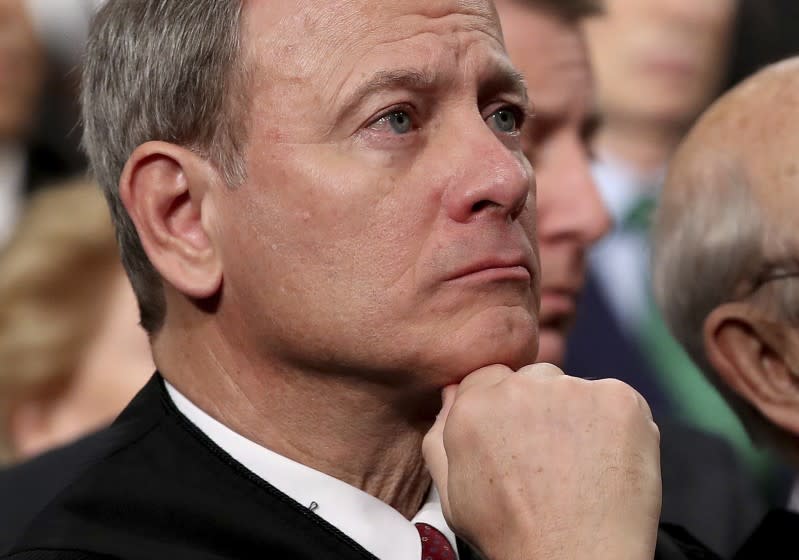 FILE - In this Tuesday, Jan. 30, 2018 file photo, U.S. Supreme Court Chief Justice John Roberts listens as President Donald Trump delivers his first State of the Union address in the House chamber of the U.S. Capitol to a joint session of Congress in Washington. Supreme Court Chief Justice John Roberts is using his annual report on the federal judiciary to highlight the steps the branch has taken to combat inappropriate conduct in the workplace. (Win McNamee/Pool via AP)