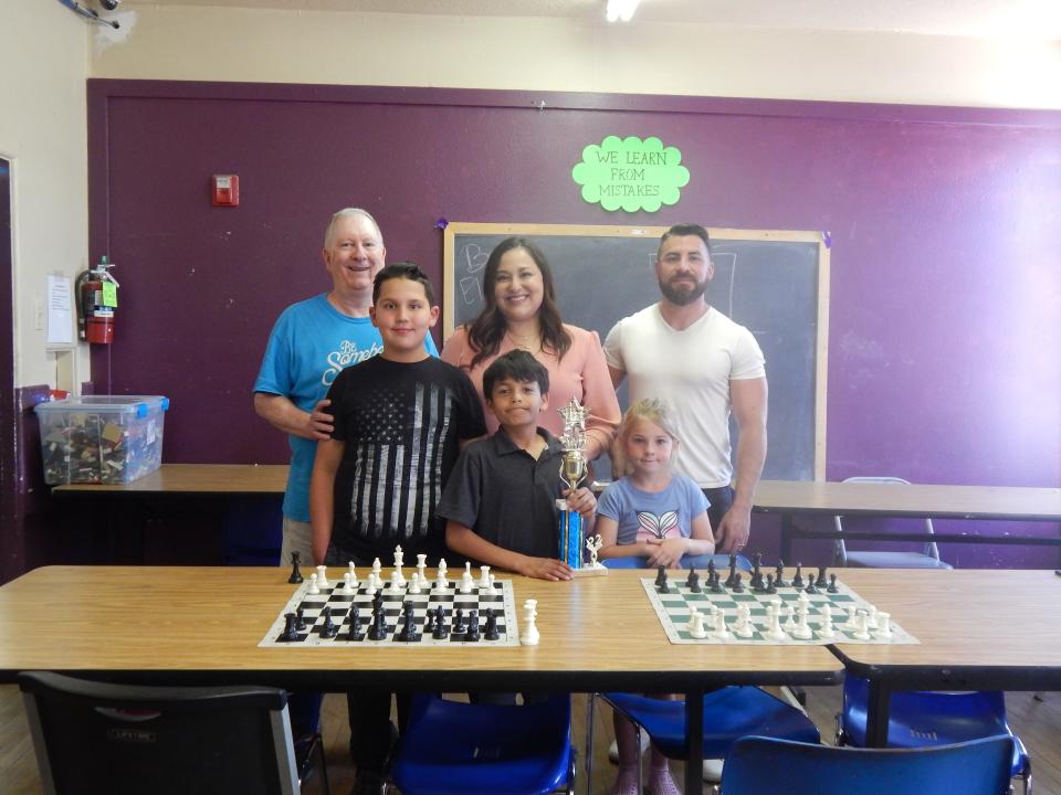 Front row from (L-R) Chris, second place; Alex, first place; Sophia, third place; Back row (L-R) Bill Bradley, chess instructor; Ashley Echavarria, CEO; Joel Montoya, Director of Operations.