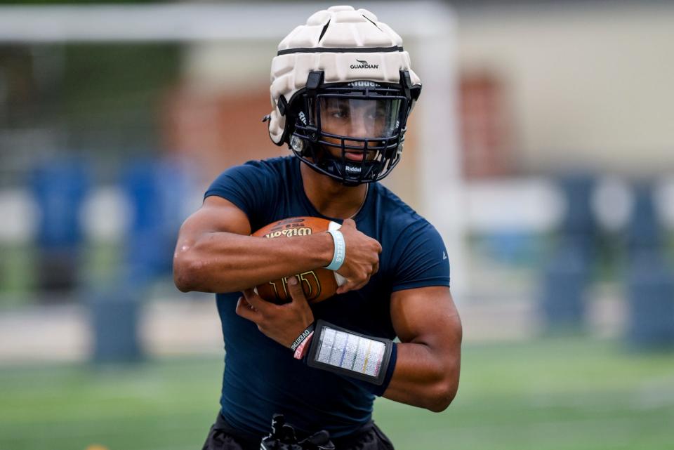 Haslett's Nakai Amachree carries the ball during football practice on Monday, Aug. 7, 2023, at Haslett High School.