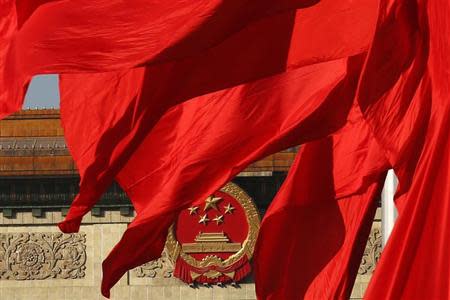 The Great Hall of the People, where the Chinese Communist Party plenum is being held, is seen behinds red flags in Tiananmen square in Beijing November 12, 2013. REUTERS/Kim Kyung-Hoon