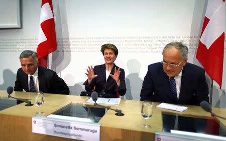 Swiss President and Justice Minister Simonetta Sommaruga (C) gestures next to Economy Minister Johann Schneider-Ammann (R) and Foreign Minister Didier Burkhalter during a news conference on immigration after the weekly meeting of the Federal Council in Bern February 11, 2015. REUTERS/Ruben Sprich