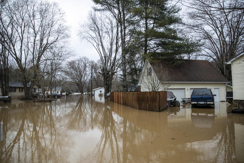 Flood water from Twelvepole Creek pushes into homes along Lynn Creek Road on Friday, Feb. 17, 2023, in Lavalette W.Va. The flooding came amid a string of thunderstorms that inundated the South and dumped nearly 3 inches (8 centimeters) of rain in parts of West Virginia. (Sholten Singer/The Herald-Dispatch via AP)