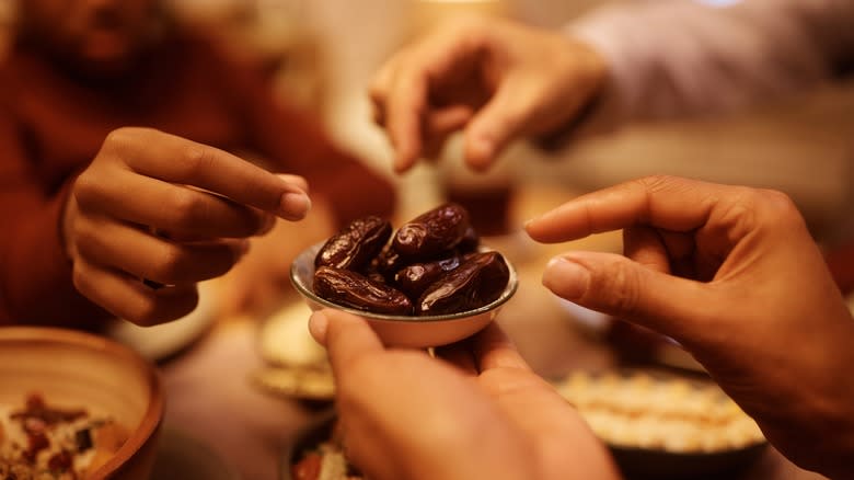 Hands grabbing dates