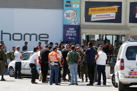 Israeli security personnel and medics work at the scene of a stabbing attack near a mall in the Gush Etzion Junction in the occupied West Bank, September 16, 2018. REUTERS/Ronen Zvulun