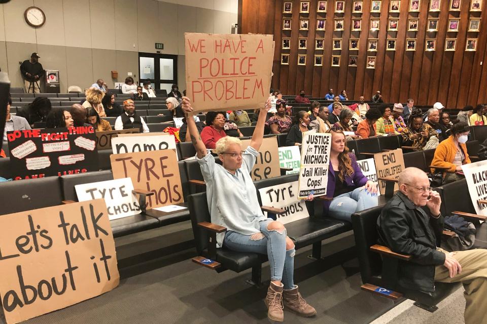 At a Memphis City Council meeting on Feb. 7, 2023, activists hold signs addressing Tyre Nichols' death by police beating.