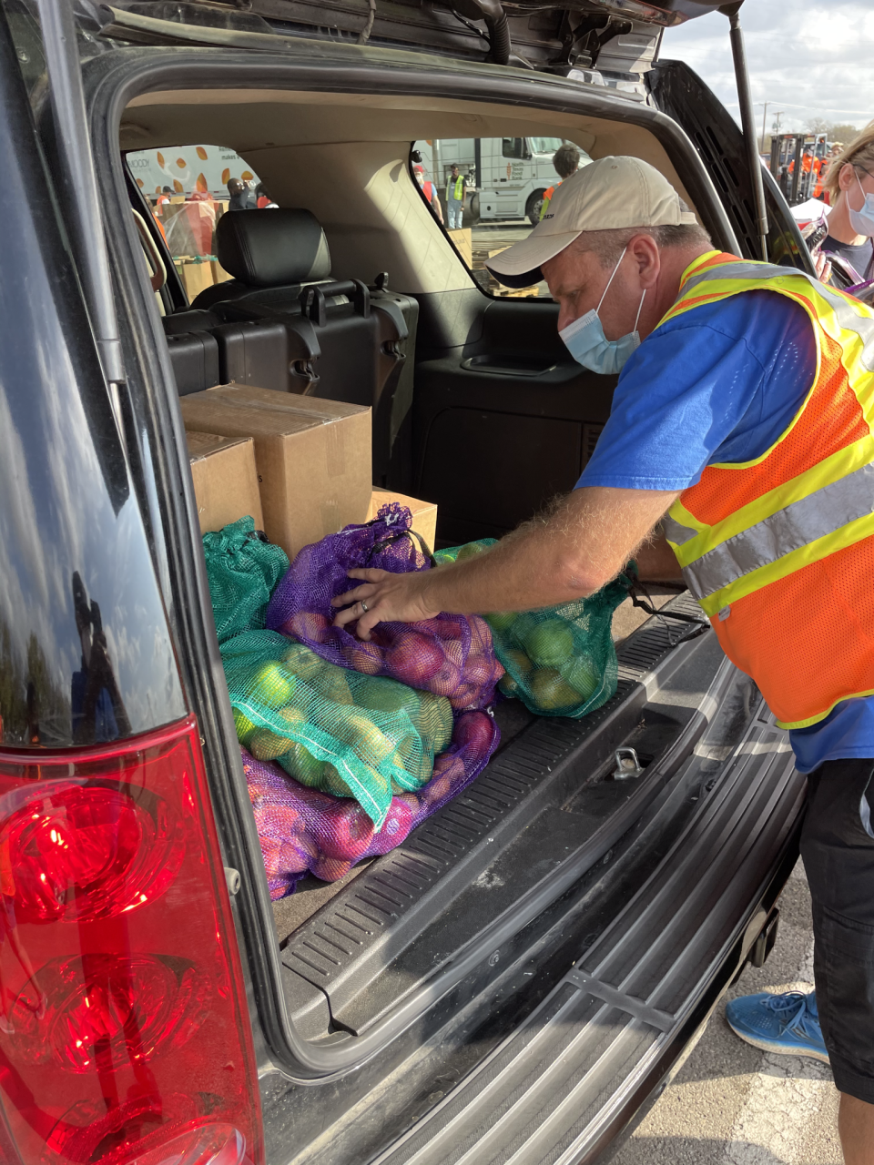 A worker is seen putting food in the trunk of a car during the event.  / Credit: Spectra/Fair Park First