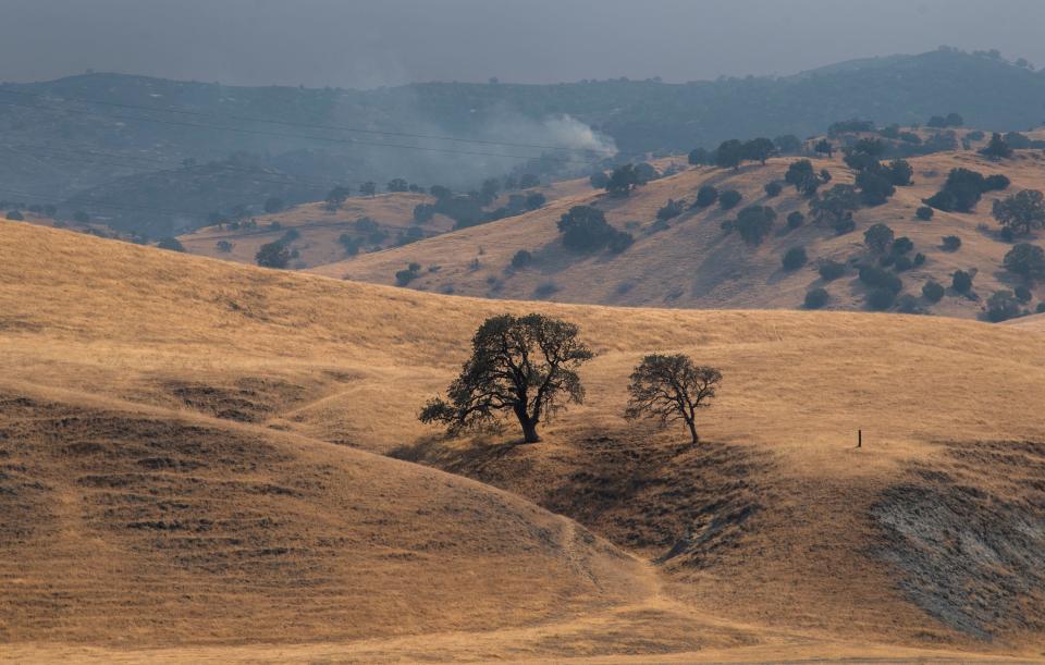 Smoke from a wildfire rises in the distance in the hills south of Tracy off Corral Hollow Road near the Lawrence Livermore National Laboratory's Site 300 testing facility in 2020. Tri-Valley CAREs will host a virtual town hall about Site 300 at 7:30 p.m., Thursday, Sept. 29.