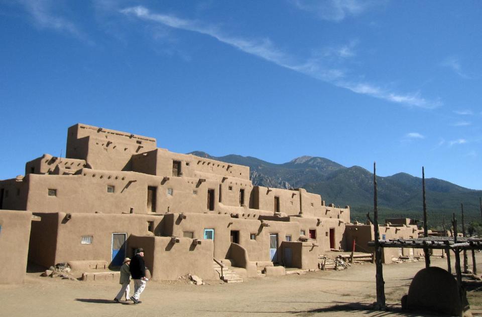 This October 2012 photo shows adobe dwellings at the Taos Pueblo in Taos, N.M., a UNESCO World Heritage site where the Taos native people have lived for 1,000 years. Tours of the pueblo describe the community’s survival and challenges across the centuries. The picture-perfect dwellings are multi-level, often with ladders to reach upper floors and round ovens outside. (AP Photo/Beth Harpaz)