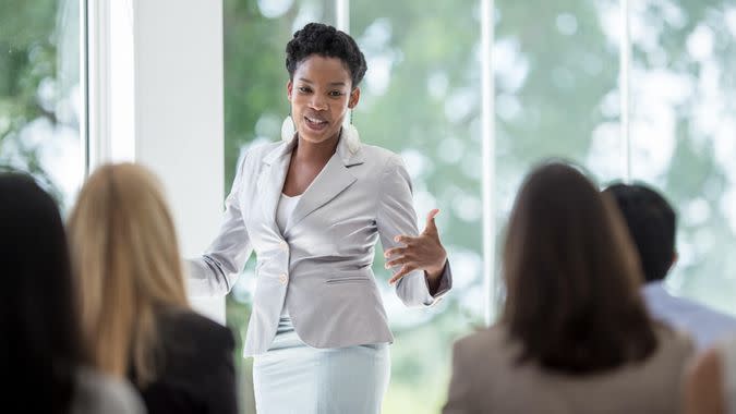 A multi-ethnic group of business professionals are getting training at the corporate office.