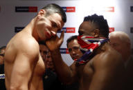 British boxer Dereck Chisora (R) slaps the face of Ukrainian heavyweight WBC boxing champion Vitali Klitschko as they stare each other out, after the official weigh-in in Munich February 17, 2012. Klitschko will face challenger Chisora in a title bout on February 18, 2012 in Munich. REUTERS/Michael Dalder (GERMANY - Tags: SPORT BOXING) FOR BEST QUALITY IMAGE ALSO SEE: GM1E8BF1Q3K01