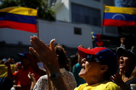 Opposition supporters waving Venezuelan flags take part in a gathering with members of Venezuela's National Assembly in La Guaira, Venezuela January 13, 2019. REUTERS/Carlos Garcia Rawlins