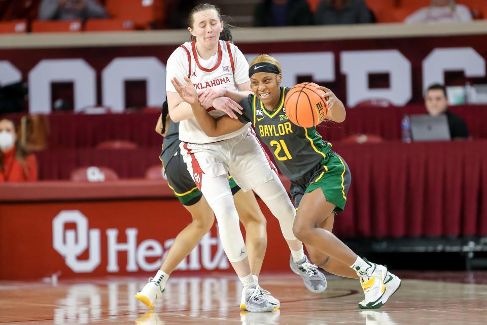 Baylor guard Ja'Mee Asberry (21) drives past Oklahoma guard Taylor Robertson (30) in the first quarter during a women’s college basketball game between the Oklahoma Sooners (OU) and the Baylor Lady Bears at Lloyd Noble Center in Norman, Okla., Tuesday, Jan. 3, 2023.