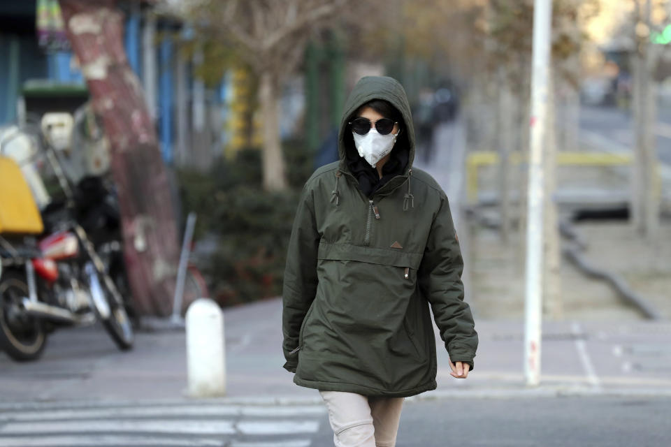 An Iranian woman wears a mask to help guard against dangerous levels of air pollution in Tehran, Iran, Monday, Dec. 23, 2019. Poor air quality forced Iran’s government on Monday to keep all schools closed in the capital, Tehran, and other cities. Schools were closed since Saturday, and will remain closed until Wednesday, the end of the week in Iran, according to the official IRNA news agency. Tehran’s air is among the most polluted in the world. (AP Photo/Ebrahim Noroozi)