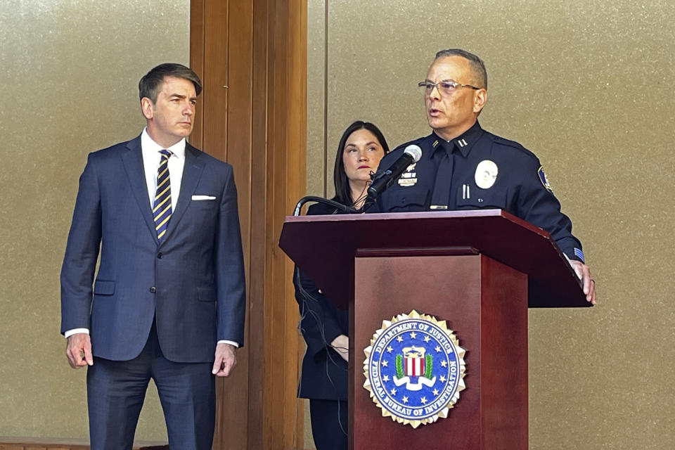 Klamath Falls Police Capt. Rob Reynolds speaks at a press conference at the FBI Portland field office in Portland, Ore., on Wednesday, Aug. 2, 2023, accompanied by John Casolino, senior assistant attorney general of the Criminal Justice Division of the Oregon Department of Justice, left, and Stephanie Shark, assistant special agent in charge with the FBI. The press conference was held to discuss the case of an Oregon man facing a federal interstate kidnapping charge after he posed as an undercover police officer to kidnap a woman in Seattle, drove her hundreds of miles to his home in Oregon and locked her in the cinderblock cell until she bloodied her hands breaking the door to escape. (AP Photo/Claire Rush)