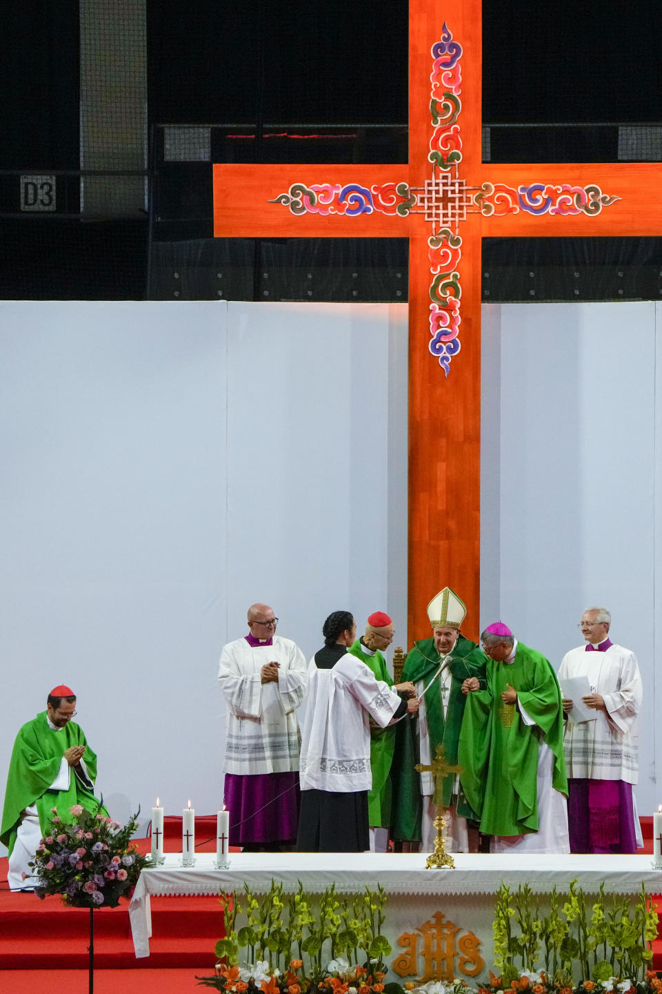 Pope Francis is joined by Cardinal John Tong Hon, at his right, and Cardinal-elect Stephen Chow, at his left, both from Hong Kong, after presiding over a mass at the Steppe Arena in the Mongolian capital Ulaanbaatar, Sunday, Sept. 3, 2023. Francis is in Mongolia to minister to one of the world's smallest and newest Catholic communities. Neighboring China's crackdown on religious minorities has been a constant backdrop to the trip, even as the Vatican hopes to focus attention instead on Mongolia and its 1,450 Catholics. At left, Apostolic Prefect for Ulaanbaatar Cardinal Giorgio Marengo looks on. (AP Photo/Ng Han Guan)