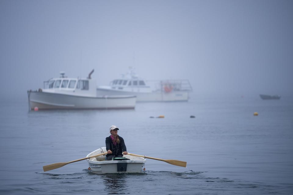 Krista Tripp rows out to where her boat is mored outside of the South Thomaston Harbor in Maine before checking on her lobster traps Friday, June 30, 2023.