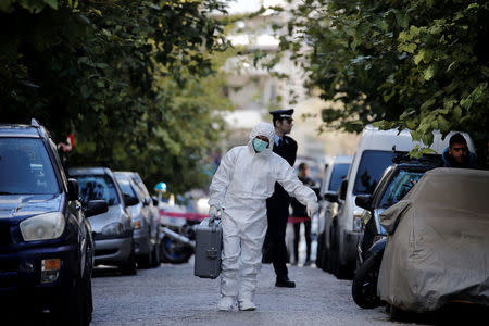 A forensics officer carries equipment following an operation in which Greek security services raided Athens apartments and found bomb-making equipment, detaining nine people on suspected links to a leftist militant group outlawed in Turkey, in Athens, Greece, November 28, 2017. REUTERS/Alkis Konstantinidis