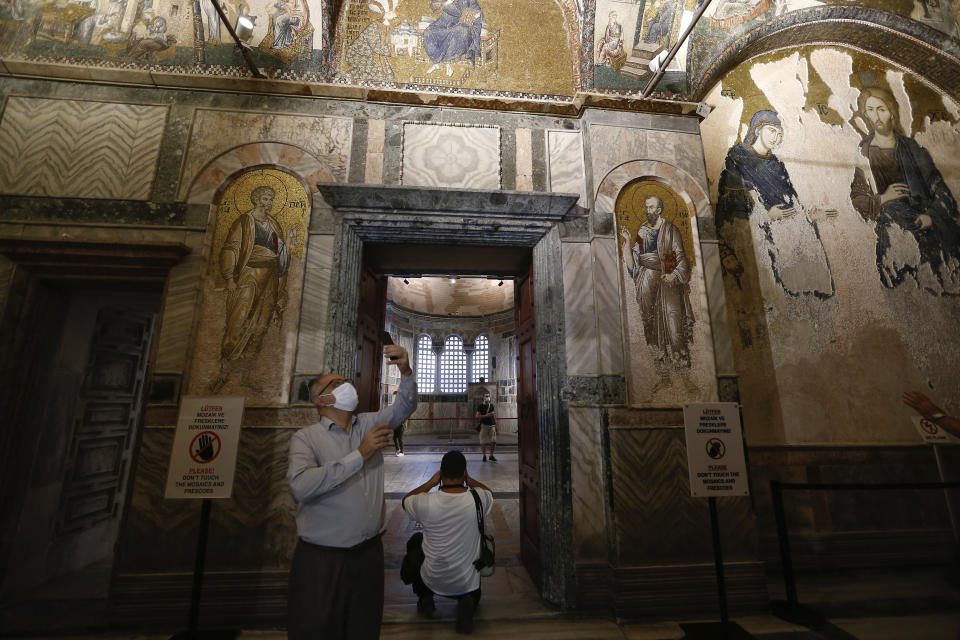 People visit St Savior in Chora church, known as Kariye in Turkish, in Istanbul, Friday, Aug. 21, 2020. Turkey on Friday formally converted former Byzantine church, St Savior in Chora, into a mosque, a month after it similarly turned Istanbul's landmark Hagia Sophia into a Muslim house of prayer, drawing international rebuke.(AP Photo/Emrah Gurel)