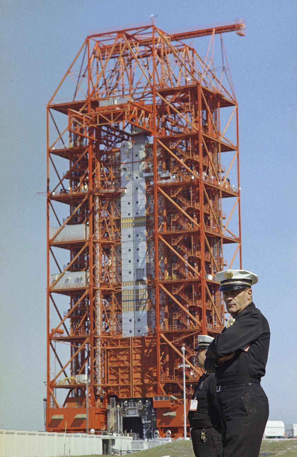 FILE - In this Jan. 28, 1967 file photo, guards stand at the Saturn 1 launch pad area the day after a flash fire killed the Apollo 1 crew at Cape Kennedy, Fla. Three astronauts, Lt. Col. Virgil Grissom; Lt. Col Edward H. White, and Lt. Commander Roger Chafee were killed when a fire erupted in their capsule on the launch pad during a preflight test for the Apollo 1, AS-204 mission. (AP Photo)