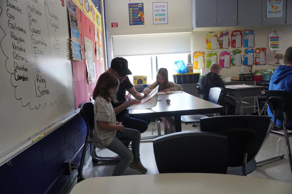 John Steinbrecher, who volunteers as a foster grandparent, helps out students at Chenango Forks Elementary School on Monday, April 15, 2024.