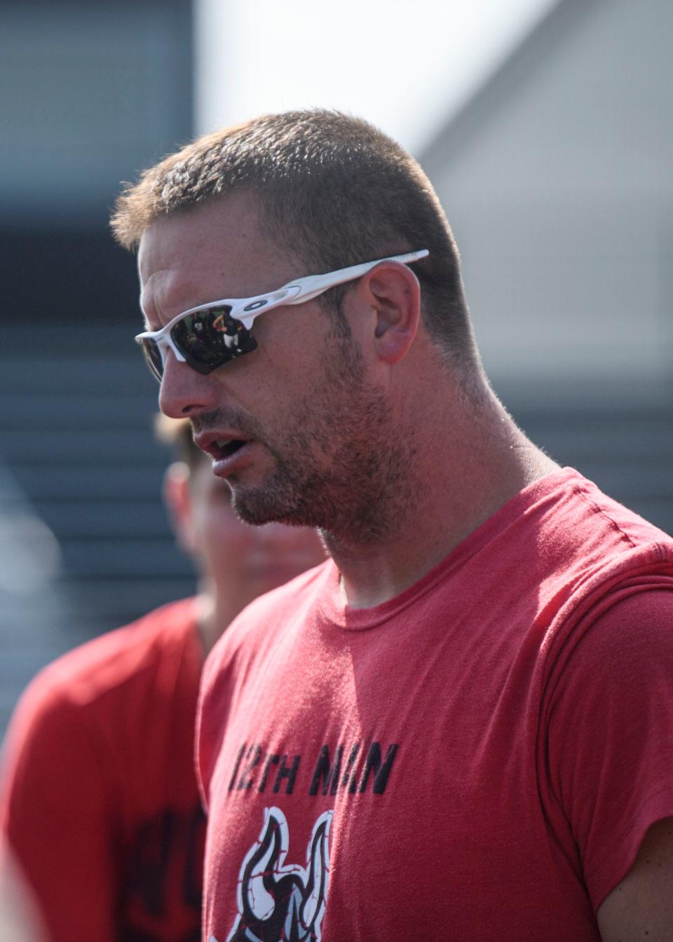 Head Coach Waylon Schenk talks to players at the end of an early morning practice on Joe Gengelbach Field at North Posey High School in Poseyville, Ind., Thursday, July 15, 2021.