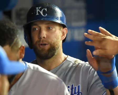 Sep 20, 2017; Toronto, Ontario, CAN; Kansas City Royals left fielder Alex Gordon (4) celebrates with teammates in the dugout after scoring against the Toronto Blue Jays in the second inning at Rogers Centre. Mandatory Credit: Dan Hamilton-USA TODAY Sports