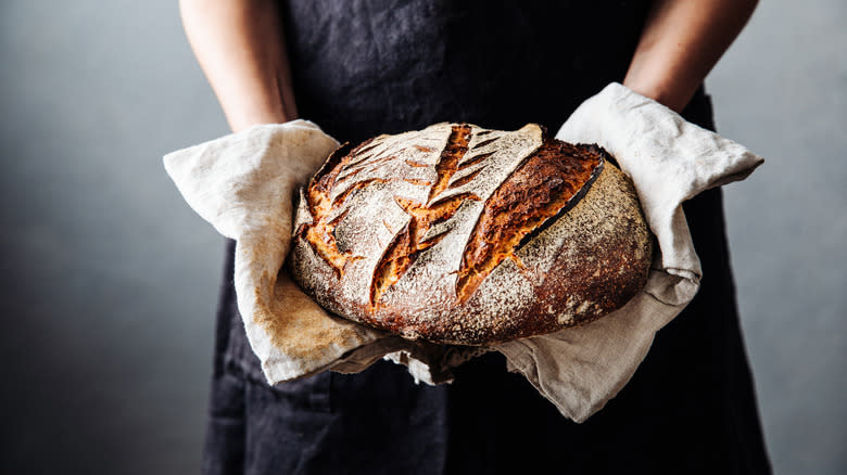 person holding sourdough loaf