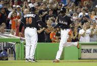 <p>Miami Marlins Dee Gordon, right, shakes hands with third base coach Lenny Harris, left, after he hit a solo home run during the first inning in a baseball game against the New York Mets, Monday, Sept. 26, 2016, in Miami. (AP Photo/Lynne Sladky) </p>