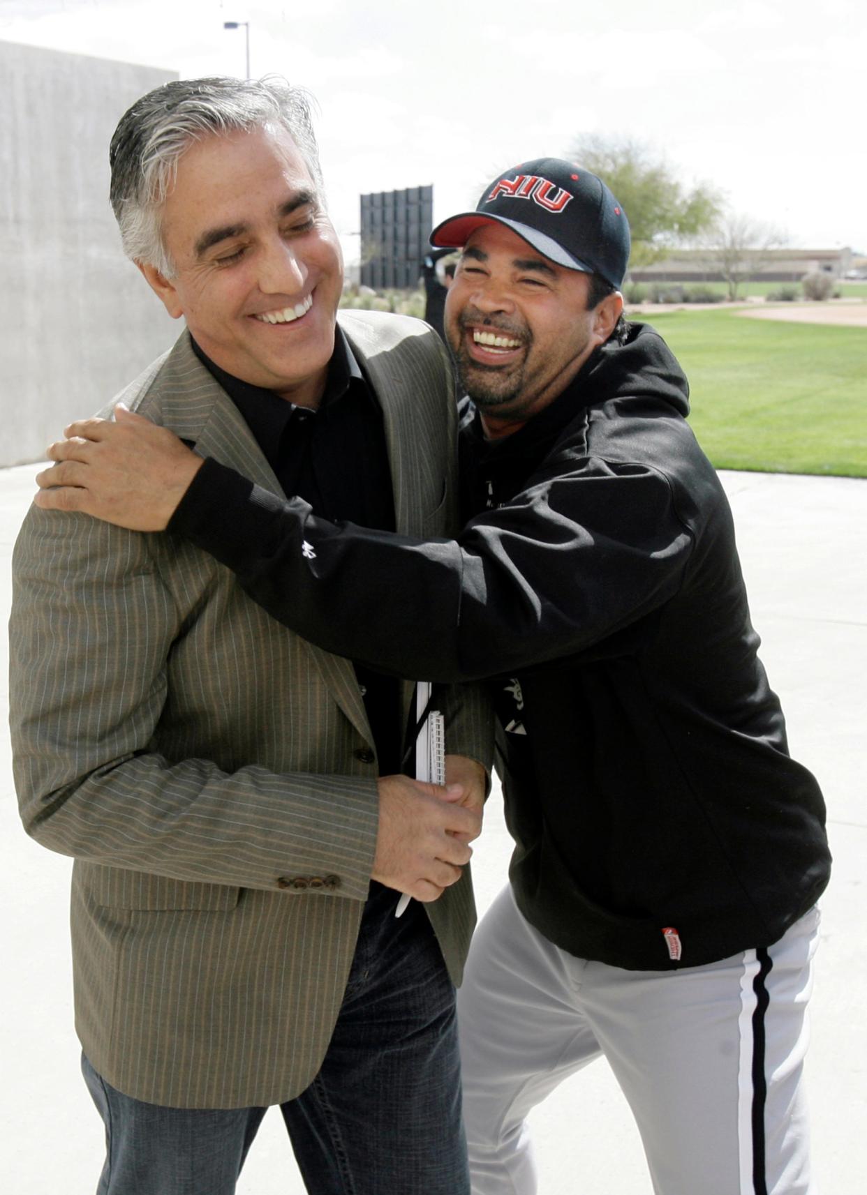In this Feb. 16, 2008, file photo, Chicago White Sox manager Ozzie Guillen (right) jokes with ESPN's Pedro Gomez after a news conference during the first day of baseball spring training for pitchers and catchers in Tucson. Gomez, a longtime baseball correspondent for ESPN and The Arizona Republic, who covered more than 25 World Series, died Feb. 7, 2021. He was 58.