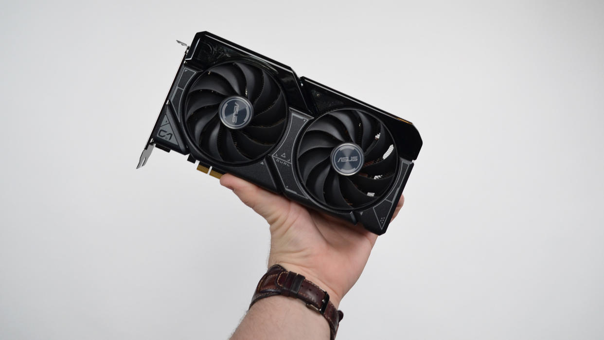  A man's hand holding up the Nvidia RTX 4060 