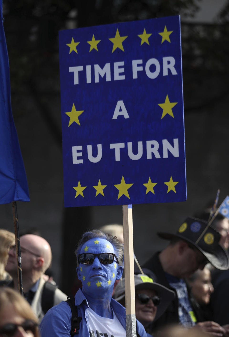 An anti-Brexit campaigner with his face painted in the colours of the European Union flag, during the People's Vote March, in London, Saturday Oct. 20, 2018. Some thousands of protesters are marching through central London, Saturday, to demand a new referendum on Britain’s Brexit departure from the European Union. (Yui Mok/PA via AP)