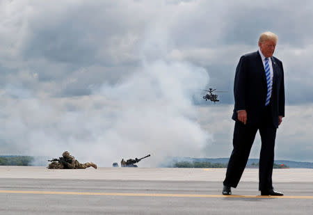 U.S. President Donald Trump observes a demonstration with U.S. Army 10th Mountain Division troops, an attack helicopter and artillery as he visits Fort Drum, New York, U.S., August 13, 2018. REUTERS/Carlos Barria