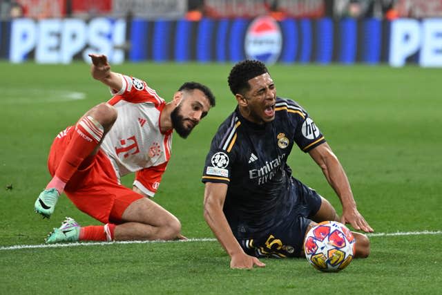 Bayern Munich’s Noussair Mazraoui, left, fouls Real Madrid’s Jude Bellingham